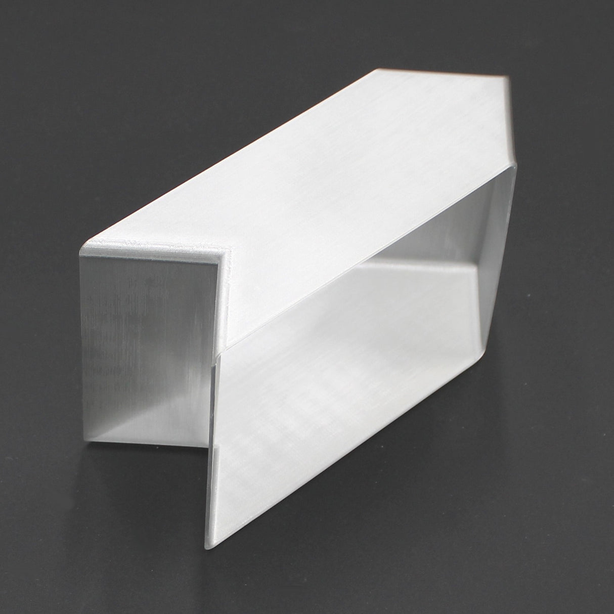 A translucent elbow connector designed for the Holston74 profile stands upright on a dark, reflective surface.