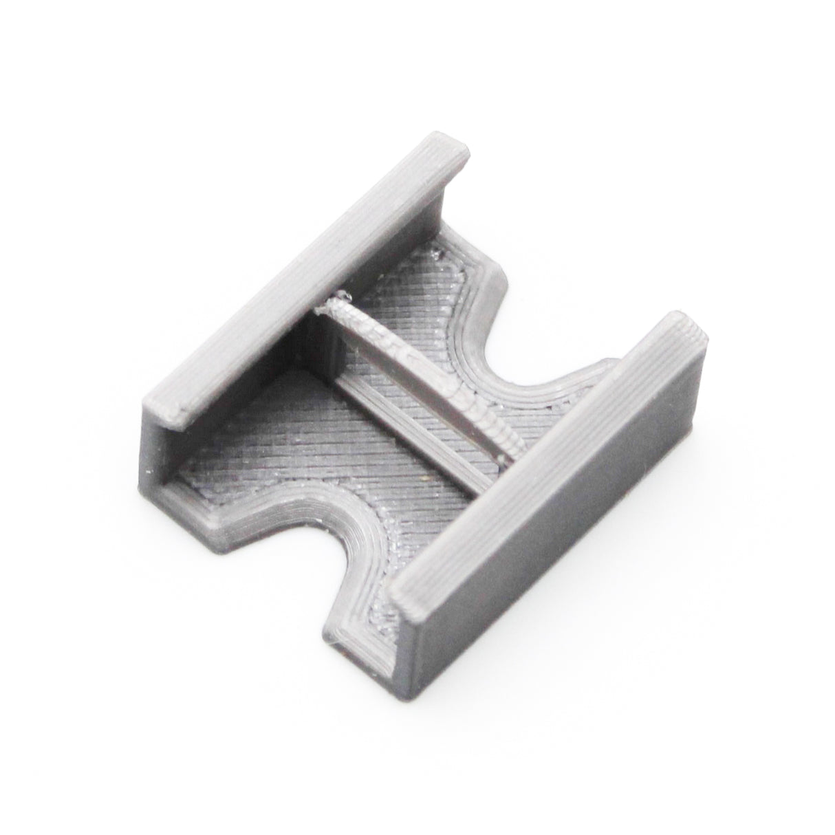 A compact, gray Linear Connector for SL7 Profile with a flat base, two parallel raised edges, and a central support bar, 3D printed and shown on a white background.