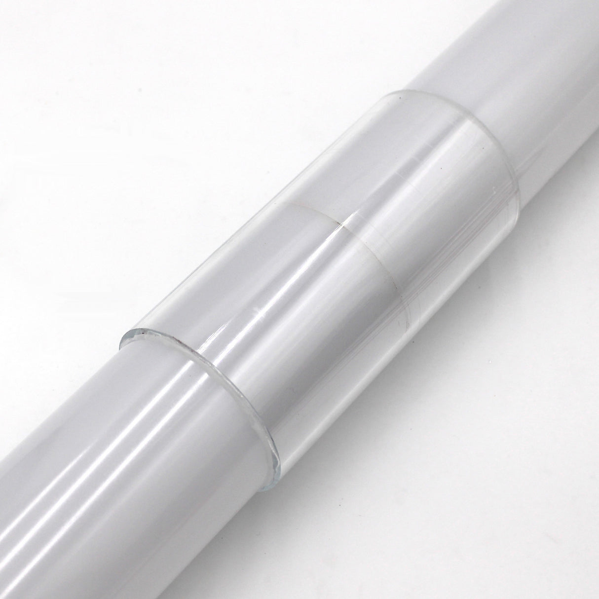 A close-up of the Clear Straight Joint for 2.75" Round Profiles, featuring a smooth, shiny, transparent surface, shown against a plain white background.