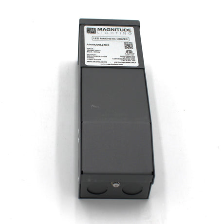 A black Magnitude M Series Dimmable Magnetic Core LED Driver (24V) with a top label showing specs and certifications, viewed from above on a white background.