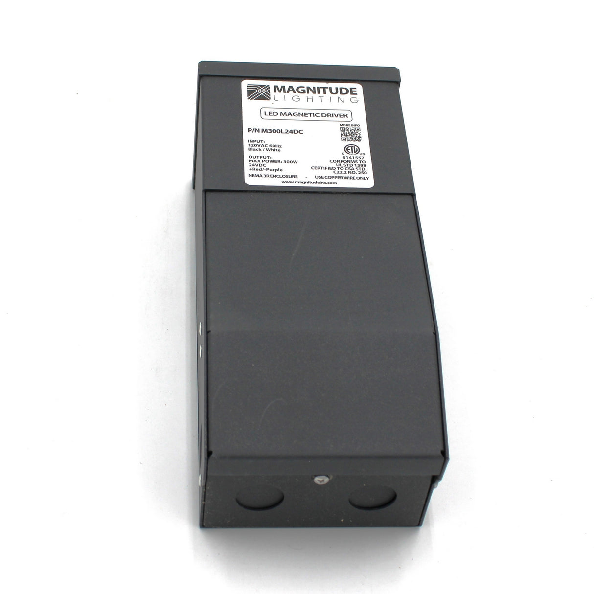 A black rectangular Magnitude M Series Dimmable Magnetic Core LED Driver (24V) with a white specification label and certification logos on top, shown from a slight angle against a white background.