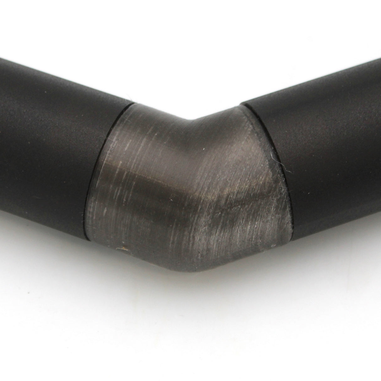 Close-up of a Translucent Elbow for Oslo Profile, showing the 90-degree angled connector joining black metal pipes. The transition between straight sections is clear against a white background.
