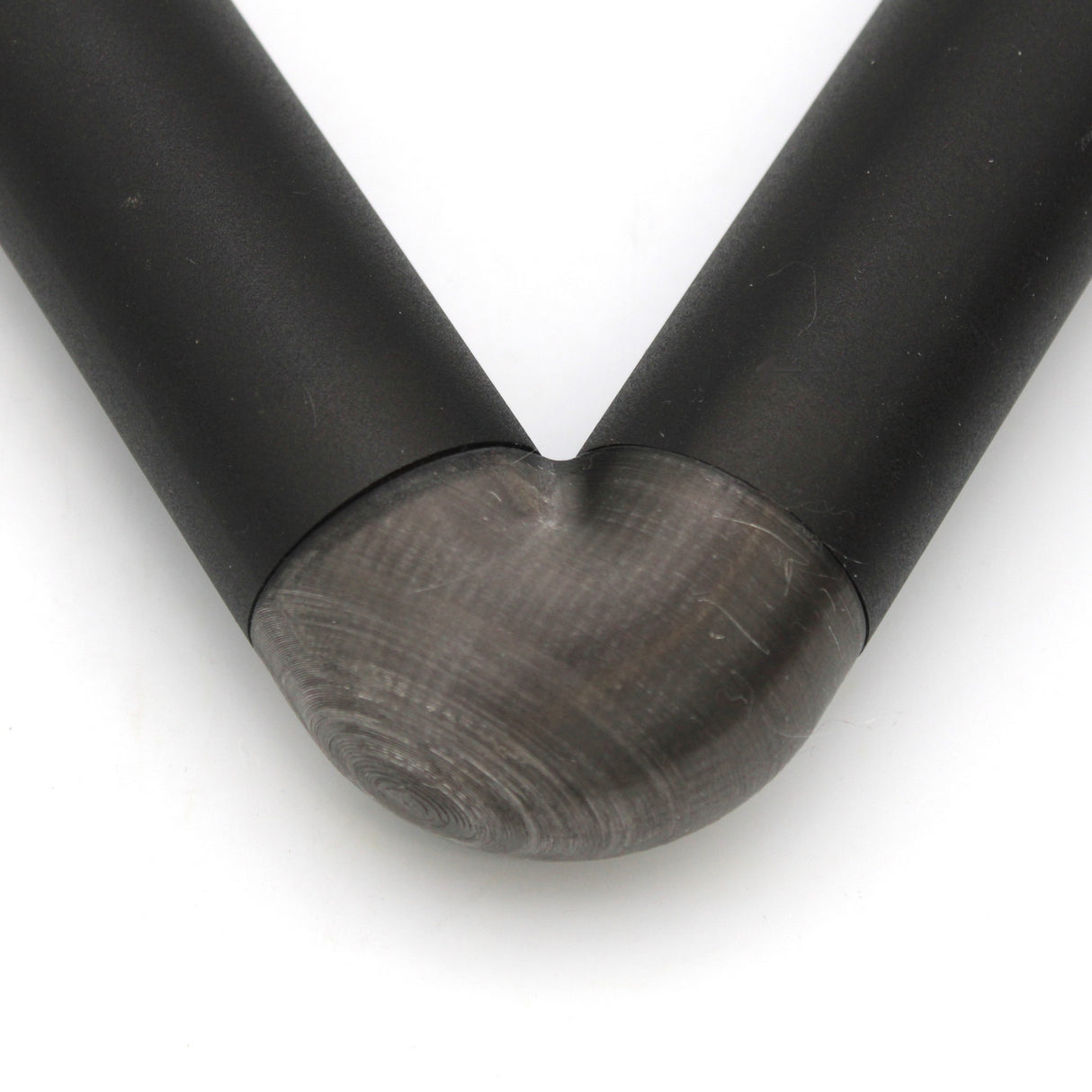 Close-up of a Translucent Elbow for Oslo Profile, bent at a smooth 90-degree angle with faint grinding marks visible along the curve.