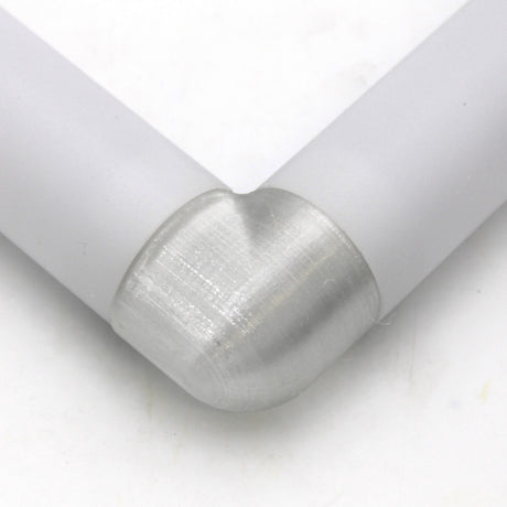 Close-up of two white Oslo profiles joined at a right angle with the Translucent Elbow for Oslo Profile, featuring a smooth, rounded connector against a white background.