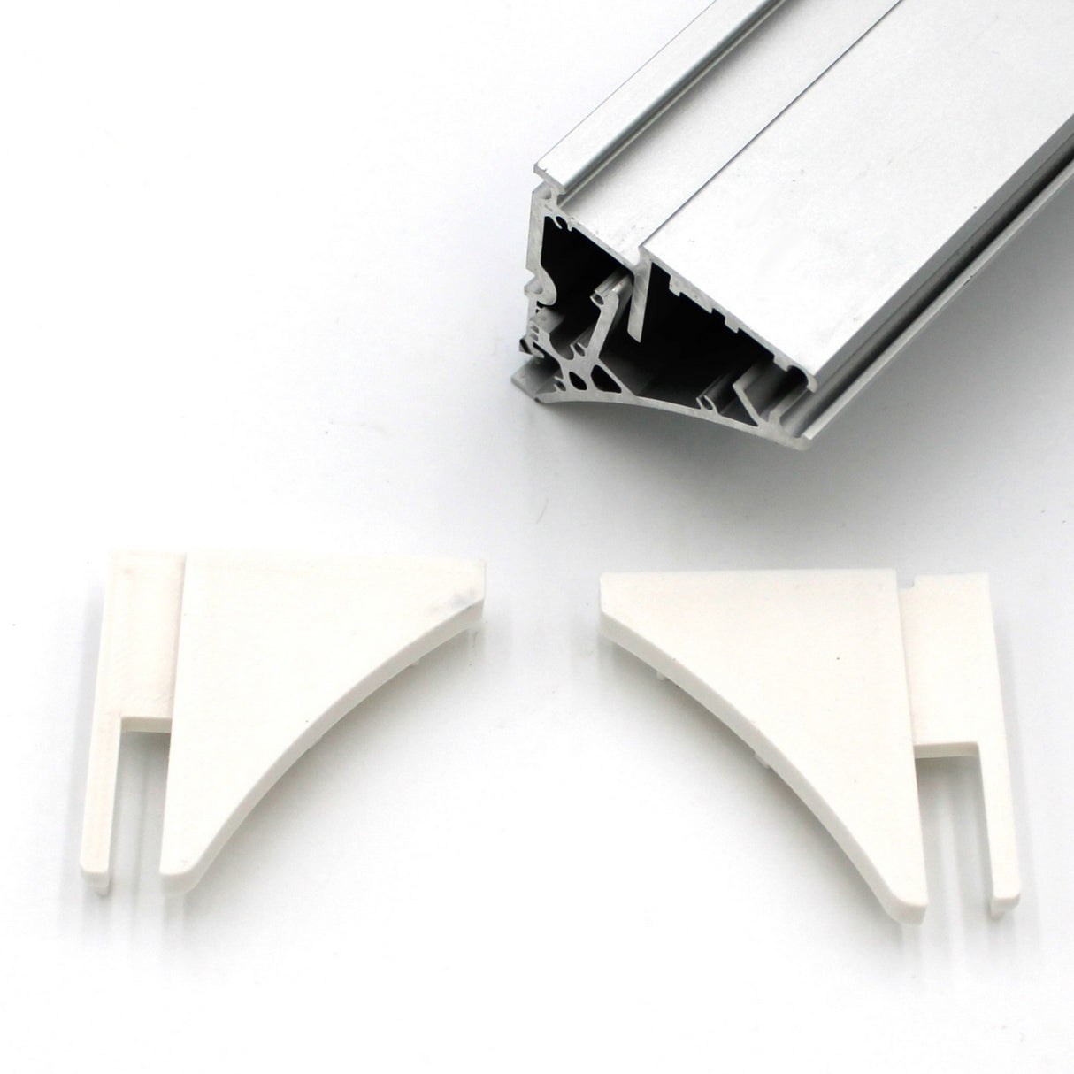 A silver end cap for the Pula P10 profile is shown above two white plastic corner brackets, all set against a plain white background.