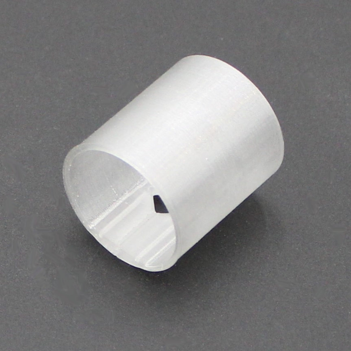 A translucent straight joiner for the Neon Redondo XL Profile, featuring a semi-transparent cylindrical white sleeve with a small rectangular side cutout, is displayed on a plain dark background.