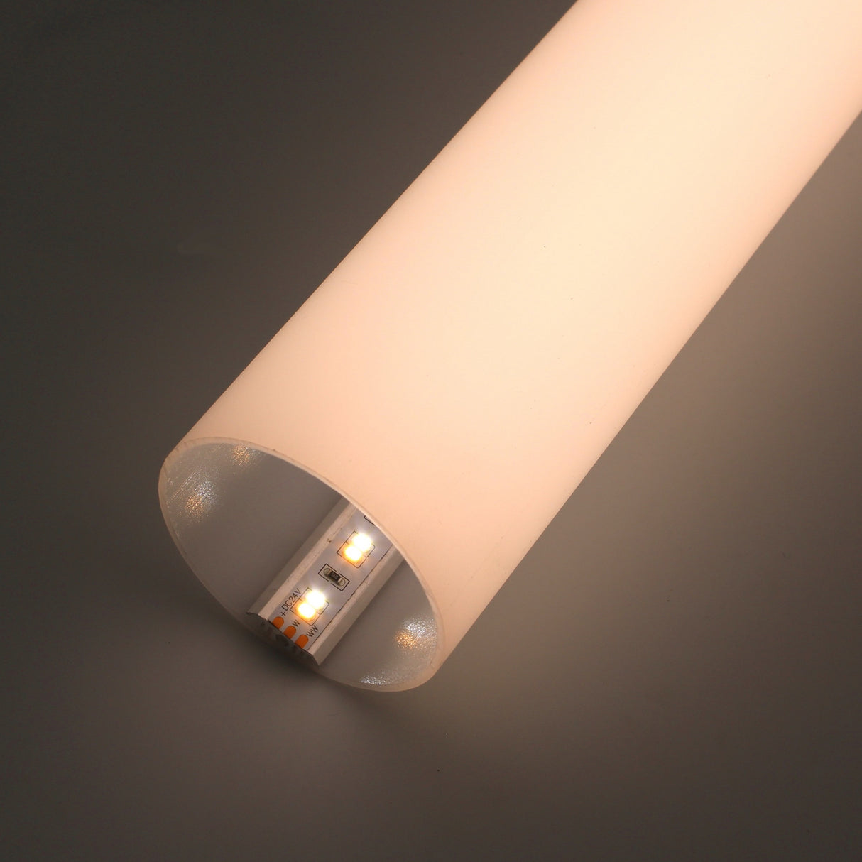 A close-up of the 2.56 Round Acrylic LED Lighting Tube (Model Sierra65) features its frosted white cover glowing warmly, with the internal LED strip visible through the open end against a neutral background.