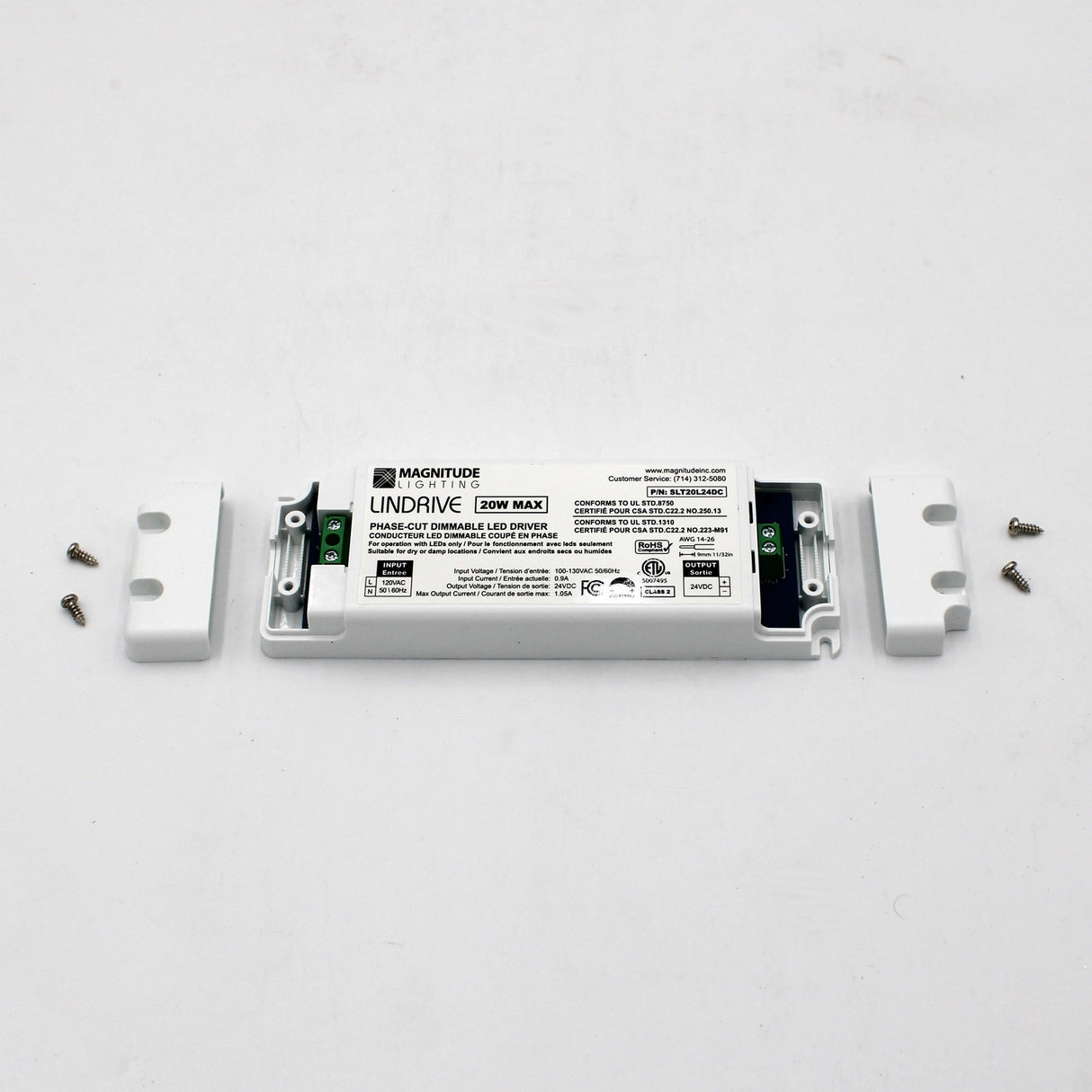 A Magnitude LinDrive Compact Electronic Phase Dimmable LED Driver (24V) with white casing is open to show its terminals, accompanied by two end covers and four screws on a plain background—perfect for under cabinet lighting.