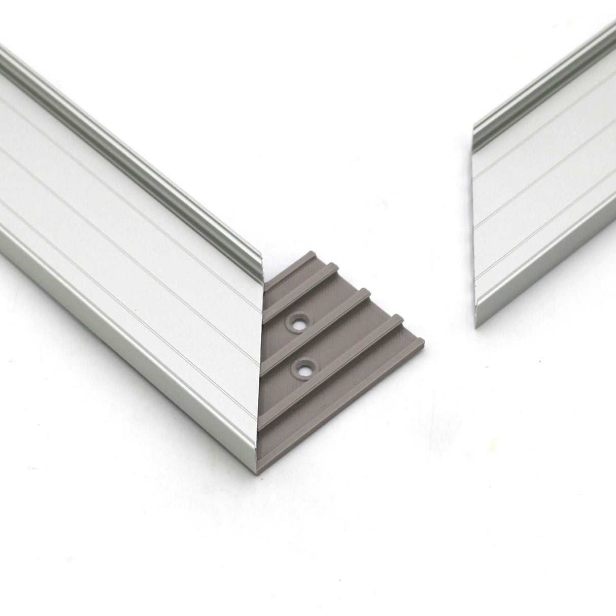 Two silver metal pieces with angled ends are joined by a gray 3D Printed Hidden Joiner and Bracket for SLW10 Profile from Wired4signs USA, featuring two screw holes, displayed against a white background.