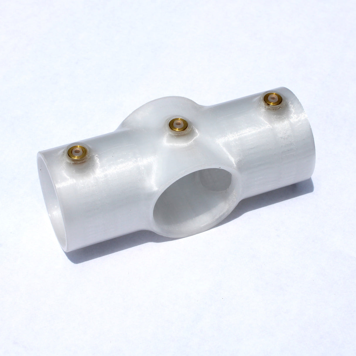 A translucent cross joint for 1.50 round profiles, featuring three openings and three brass screws, displayed on a plain white background.