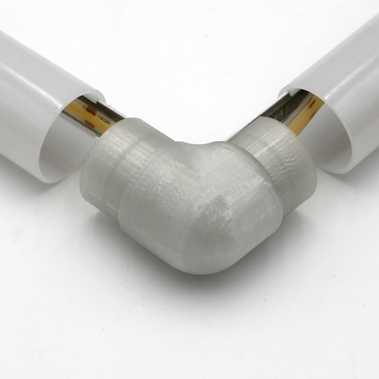 Close-up of the Translucent Elbow for Smokies38 Profile connecting two white diffuser tubes, showing visible internal wiring.