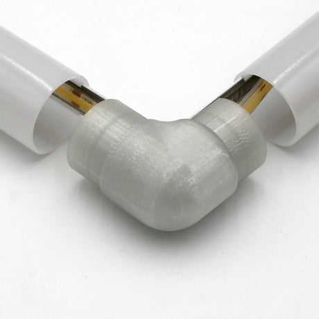 Close-up of the Translucent Elbow for Smokies38 Profile connecting two white diffuser tubes, showing visible internal wiring.