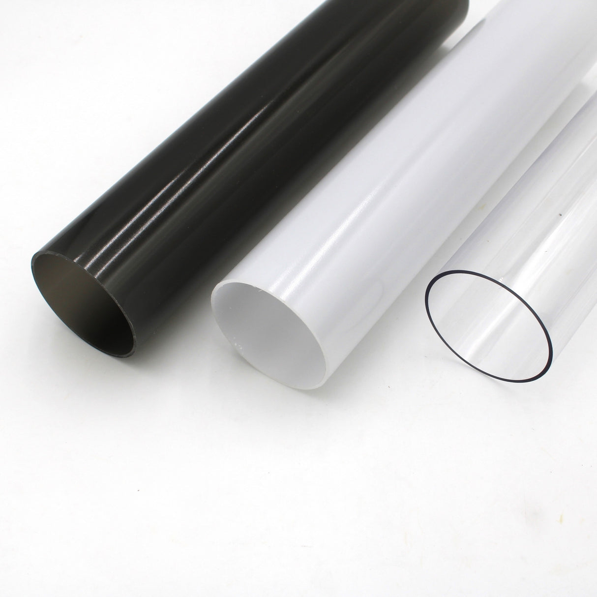 Three 2.75 Round Polycarbonate LED Lighting Tubes (Model Smokies70)—black, white, and transparent—are shown side by side on a white surface, ideal as LED diffusers.