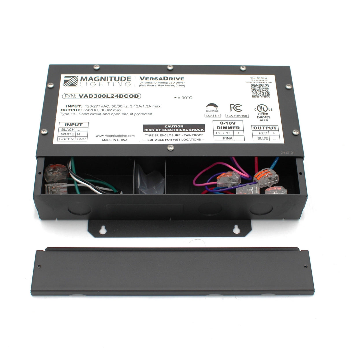 Rectangular black 5-Way Universal Dimmable Constant Voltage LED Driver (24V) with removable cover reveals internal wiring and terminal blocks. The Magnitude VersaDrive label shows specs, certifications, instructions, and universal dimming.