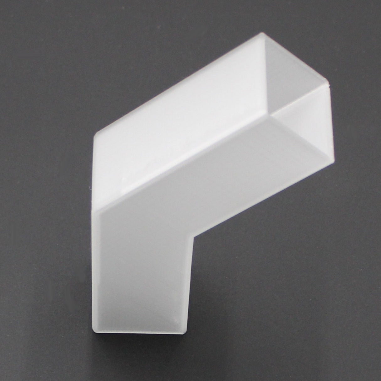 A Translucent Elbow for Visby Profile, featuring clean edges and an L-shaped acrylic form, is displayed on a dark gray background.