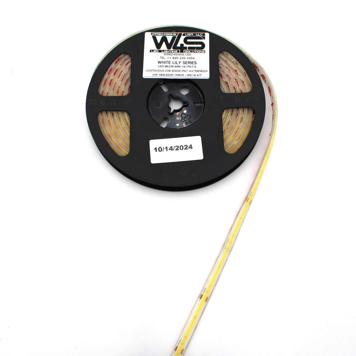 A spool of Continuous COB IP67 LED Strip (24V) ~ White Lily Series features a yellow strip partially unwound to the right, on a black reel labeled 10/14/2024, providing dot-free light ideal for decorative lighting.