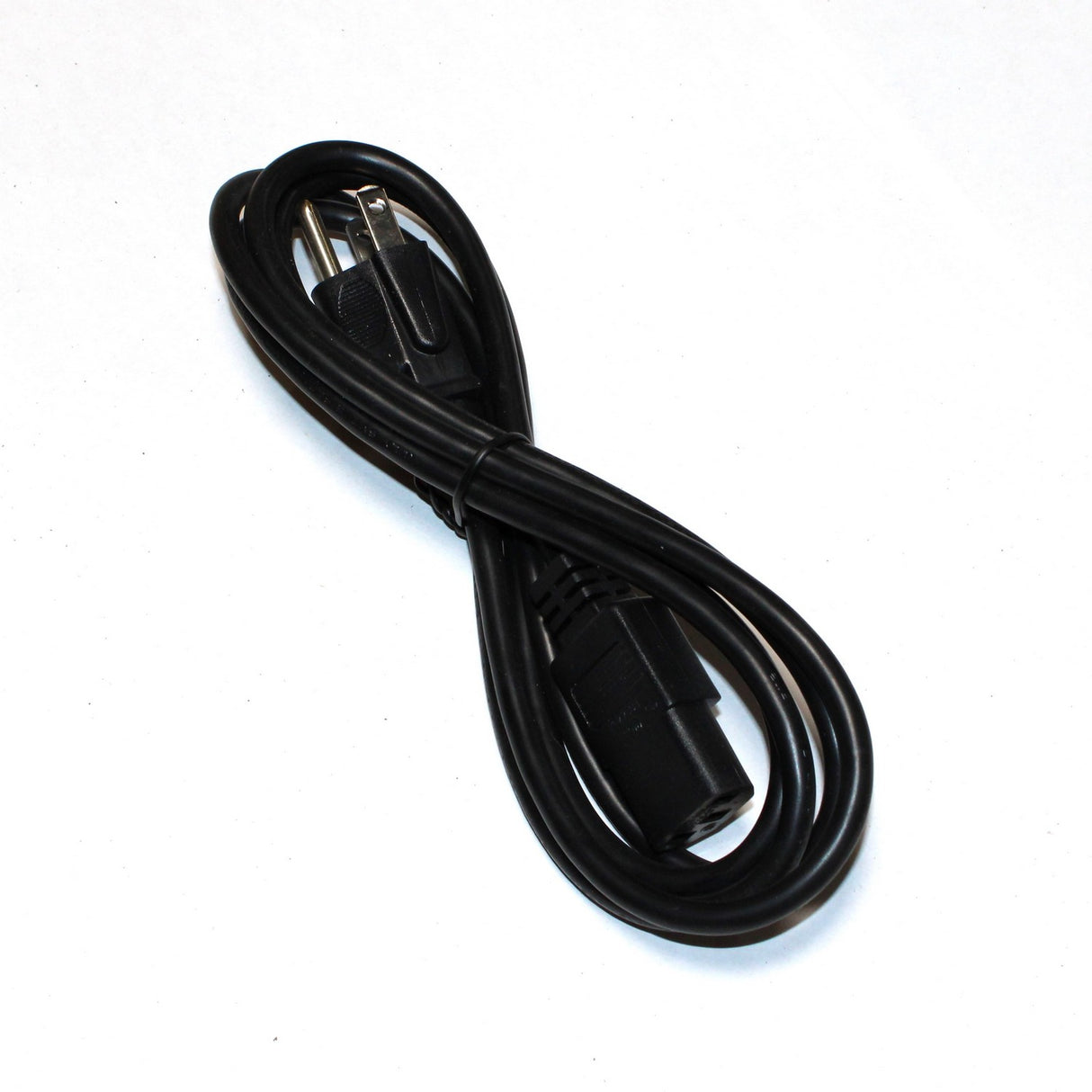 The Kettle Cord for Desktop PSU is a coiled black power cable with a standard two-prong plug and female connector, displayed on a white background. Bulk pricing available.