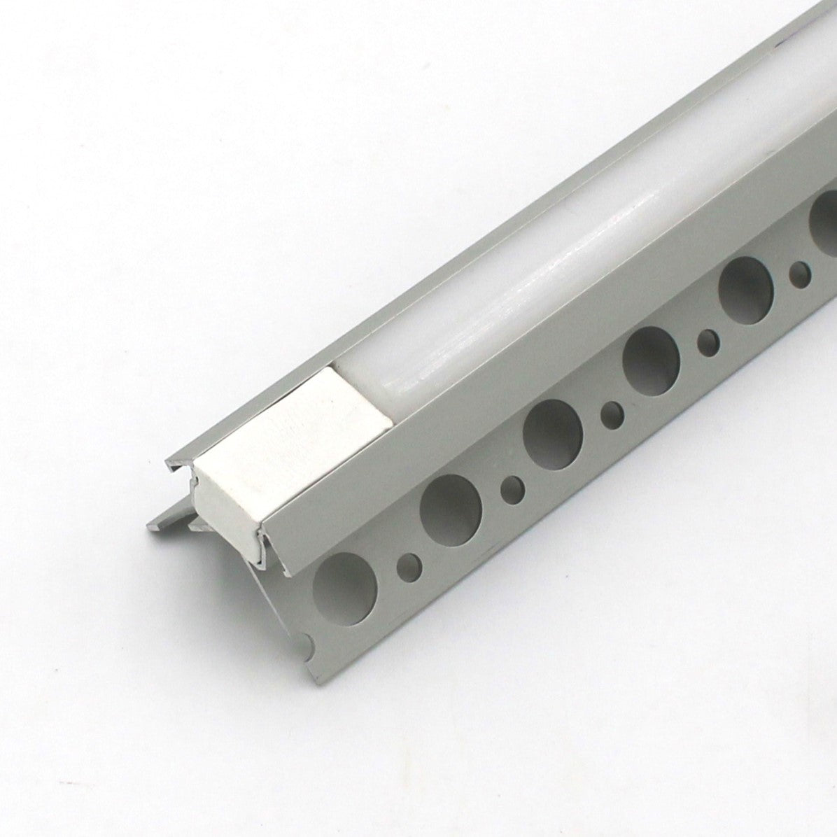 A close-up of an RGB LED Tile Light Strip Kit for Outside Corners (24V) ~ Nicho Series, featuring a silver aluminum channel with circular holes and white insert, ideal for tile edging or mounting RGB LED strips against a plain white background.