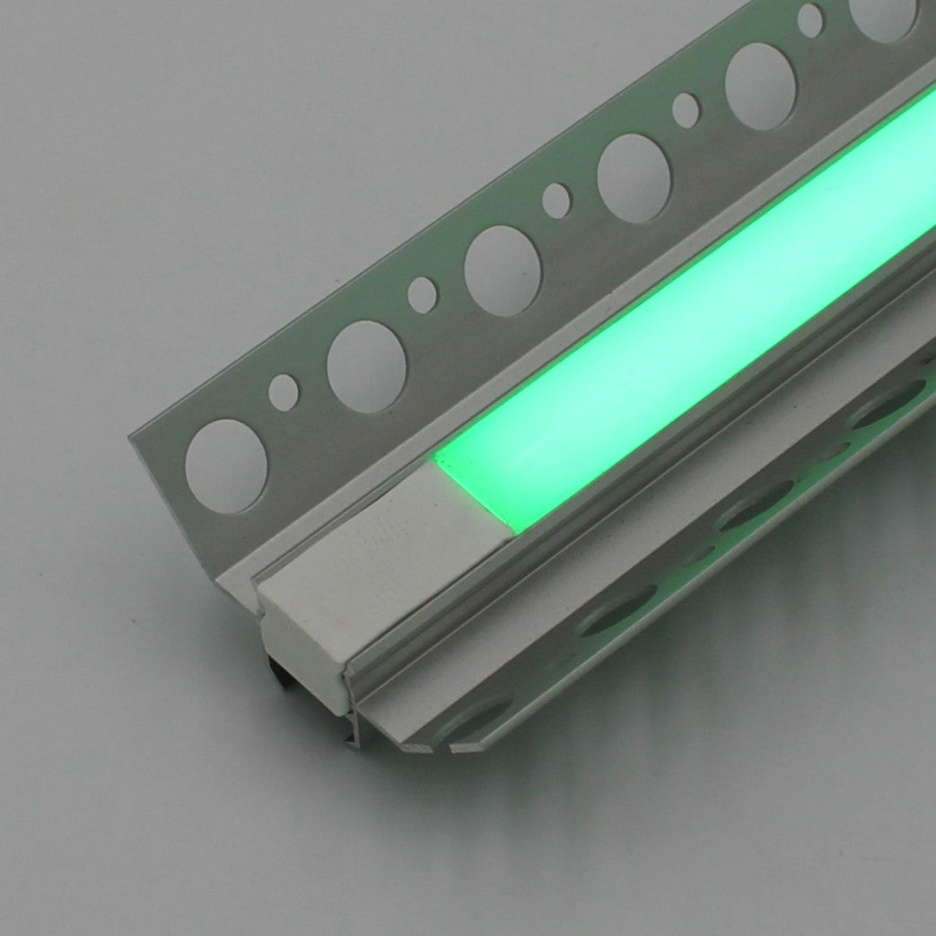A close-up of the RGB LED Tile Light Strip Kit for Inside Corners (24V) ~ Nicho Series, with a glowing green strip and perforated aluminum mounting brackets on a gray background.