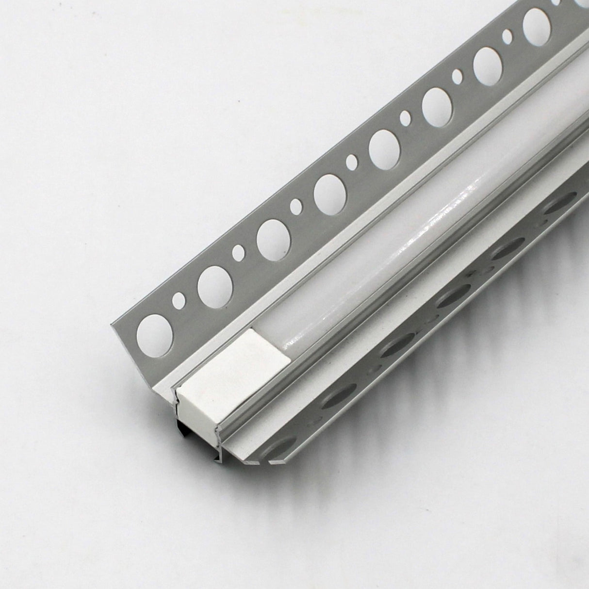 A close-up of the White LED Tile Light Strip Kit for Inside Corners (24V) ~ Nicho Series, featuring an aluminum channel and perforated metal flanges for recessed tile installation, shown on a white background.
