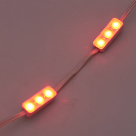 Two white Mini3 Color 160 Mini LED Modules, each with three bright red wide-angle LEDs and white connecting wires, glow against a plain background. IP68 waterproof, they offer reliable lighting for diverse environments.