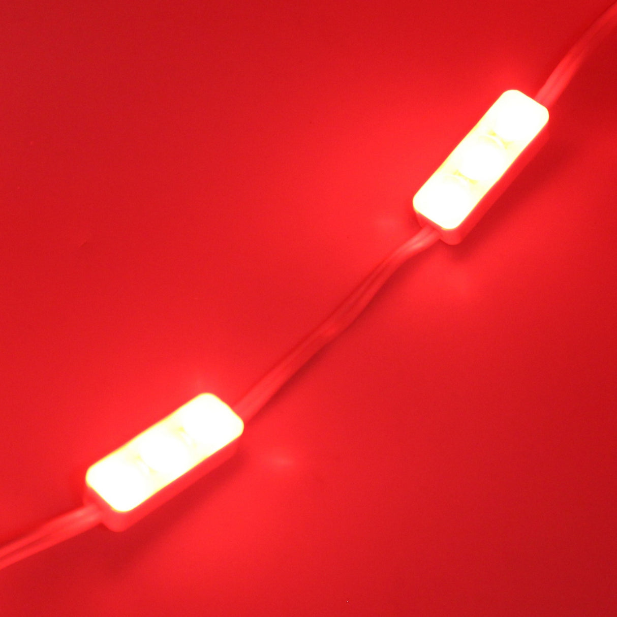 The Mini3 Color 160 Mini LED Module ~ Wide Angle Series features two compact rectangular LEDs on a wire, emitting vivid red light. Its wide-angle lens provides bright, even illumination in all directions.