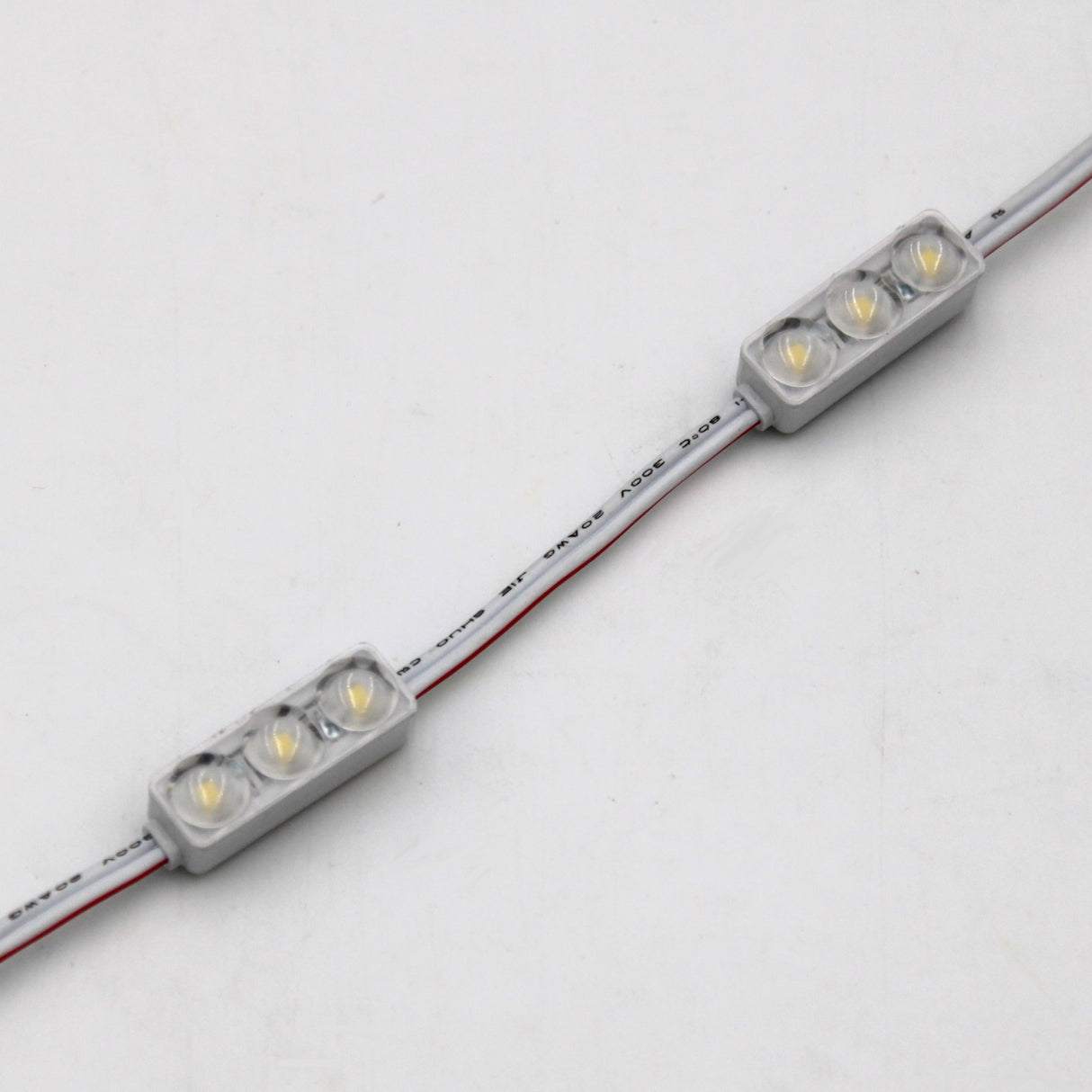 Two Mini3 White 160 Mini LED Module ~ Wide Angle Series, each IP68 waterproof and featuring three yellow LEDs under a clear cover, are linked by a white wire against a plain white background.
