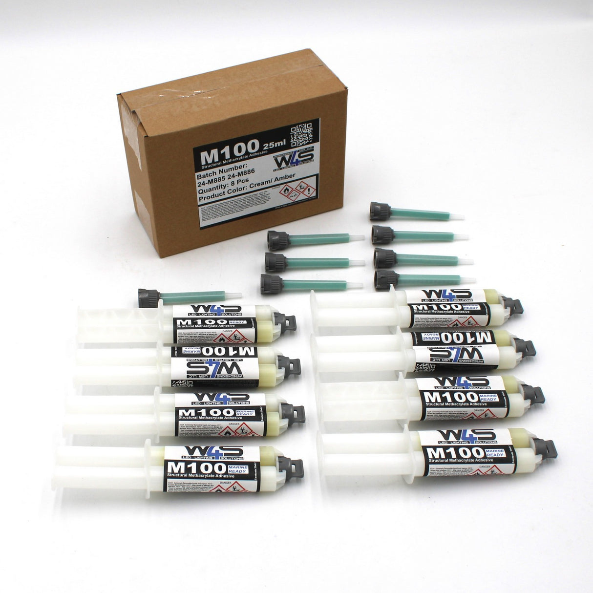A brown box labeled “W4S M100” contains six 25ml 2-part Marine Methacrylate Adhesive syringes (1:1 B-System), each with a green mixing nozzle and black cap—ideal for high strength bonding applications.