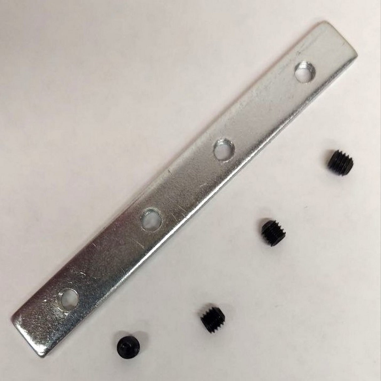A 180 Degree Straight Connector for HR-MAX and Hannover Profile, shown with four black set screws, rests on a plain white surface.