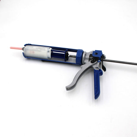 A close-up of the Caulking Gun Adaptor for Methacrylate 50ml 10:1 Mix (Round Flange), loaded with a blue and silver caulking gun and pink-nozzled 2-part adhesive cartridge, on a white background.