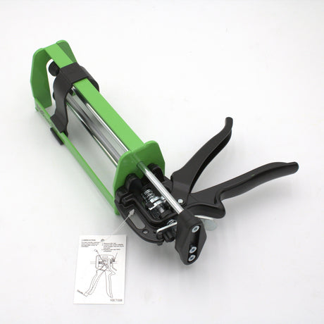 A Manual Cartridge Gun for Methacrylate 400ml 1:1 Mix with a green and black metal frame and trigger handle is on a white surface, next to an instruction sheet with a diagram, ideal for 400ml adhesive packs.