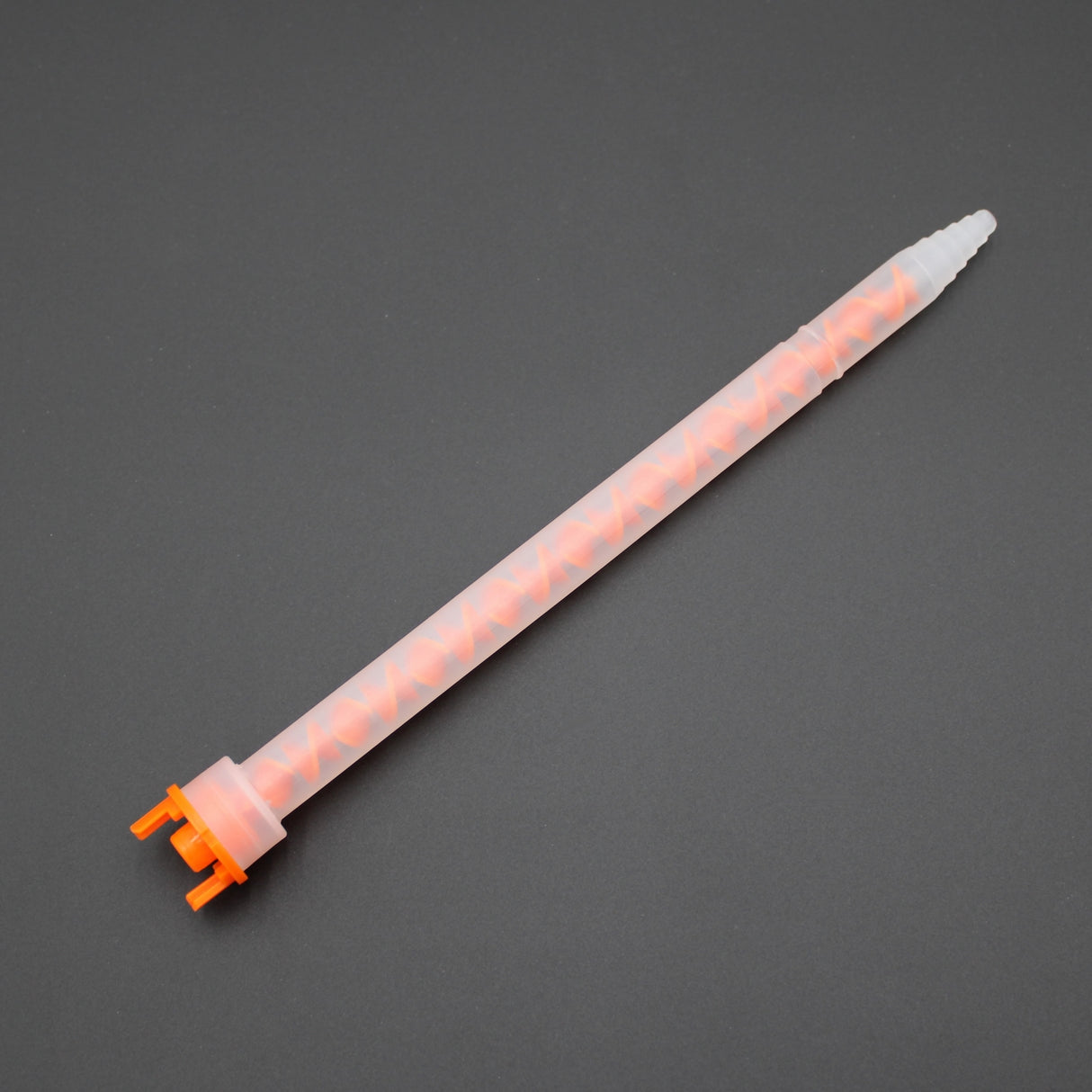 The Static Mixer for 2-part Methacrylate 500ml 10:1 Mix ~ F-System Snap-In, featuring an orange base and clear tube that displays the spiral mixing element, is shown on a dark gray background.