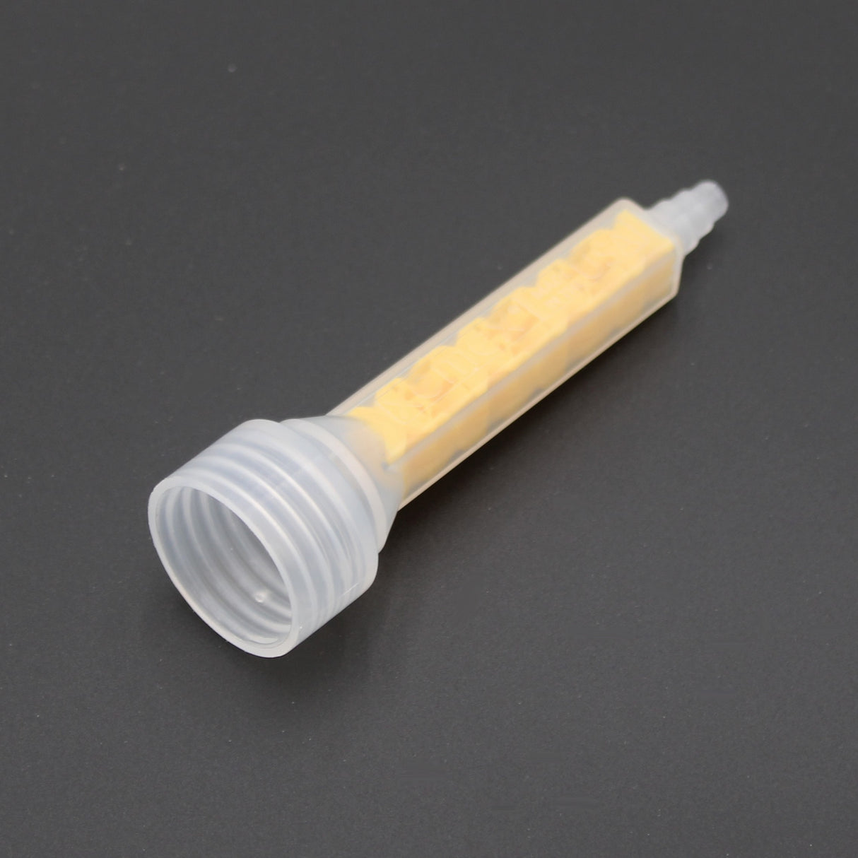 The High-Performance All-Ratio Mixer for 2-Part Methacrylate ~ Xemex C-System Threaded, with a clear plastic body and yellow spiral element, is shown against a plain dark background.