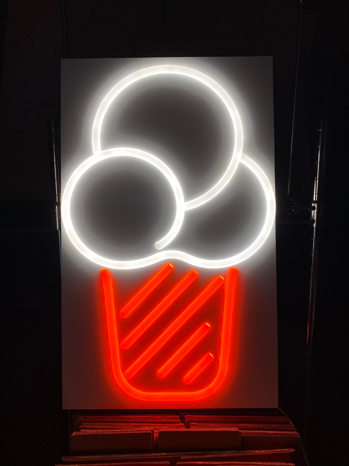 A neon sign with a red ice cream cone and three white scoops uses Marsella Flexible Color Diffusers for LED Strip, crafted from silicone LED diffusers and displayed beautifully against a dark background.