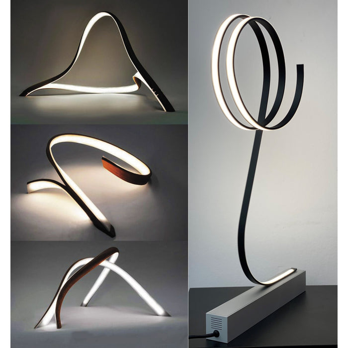 Four sculptural, modern LED lamps feature abstract, looping curves and lines, each crafted with the Ultra Thin Bendable LED Strip Channel ~ Model Milano Slim for unique flowing forms illuminated by soft white light against a plain background.