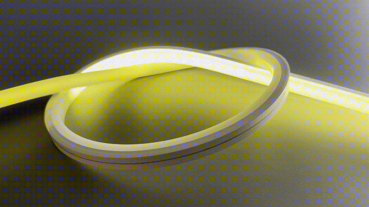 The Pixel IP44/IP66 Neon Flexible LED Light Line (24V) ~ Flex Slim Series, glowing in yellow, is coiled on a smooth, neutral surface, forming a loop that emits soft illumination and casts gentle shadows.