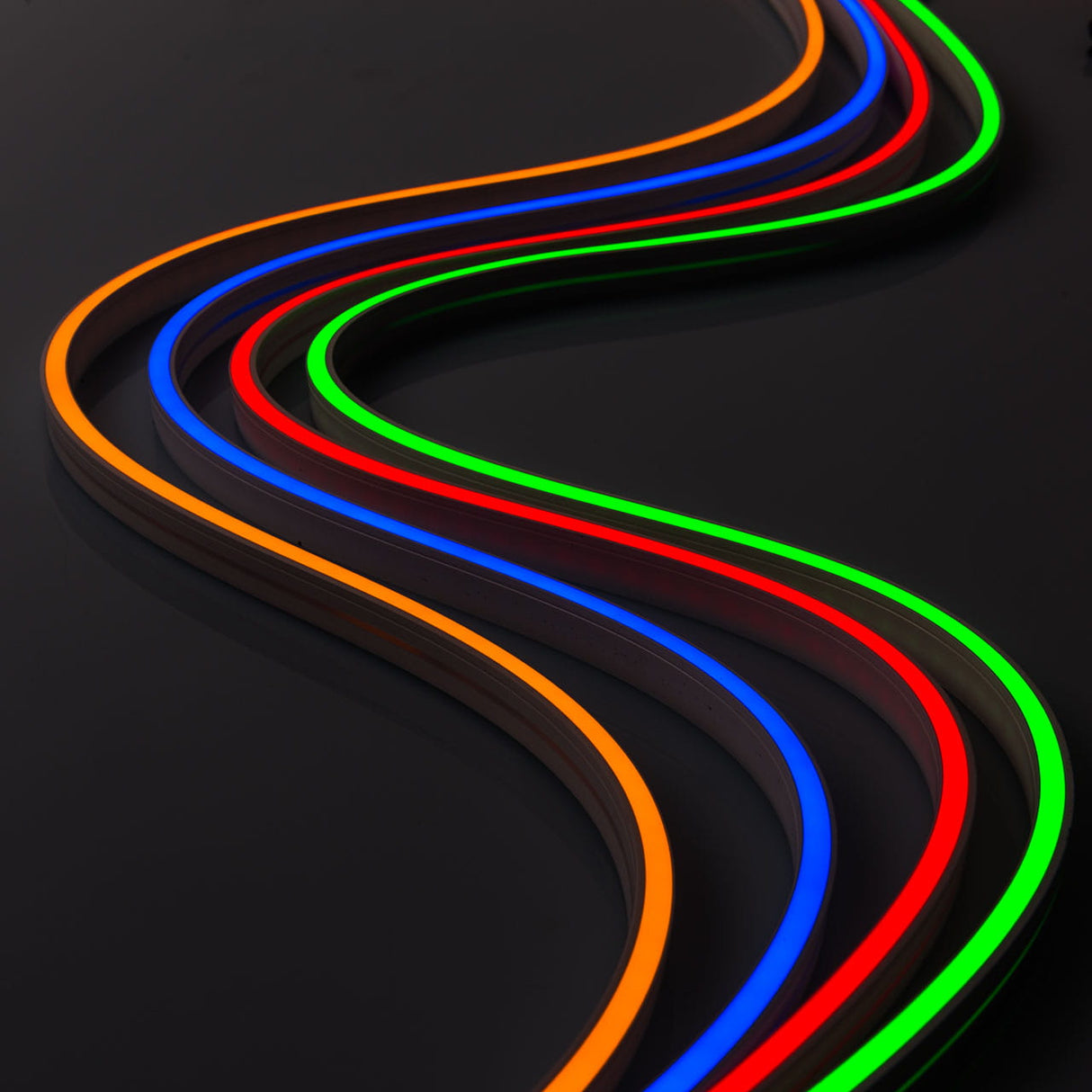 Curved lines of Pixel IP44/IP66 Neon Flexible LED Light Line (24V) ~ Flex Super Slim Series in orange, blue, red, and green illuminate a dark glossy surface, creating a vibrant wavy abstract pattern.
