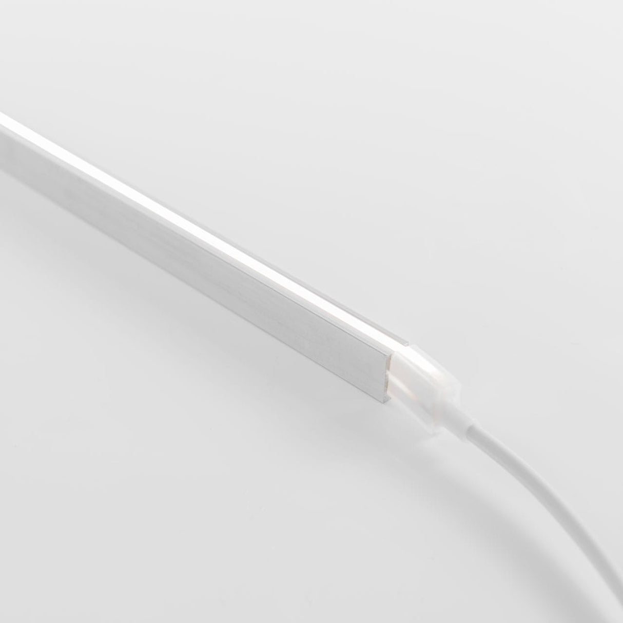 A slim, rectangular LED light bar with a white frame and power cable is shown on a white background, highlighting its compatibility with the Mounting Clips for Neon Flex Ultra Slim Series for easy installation.