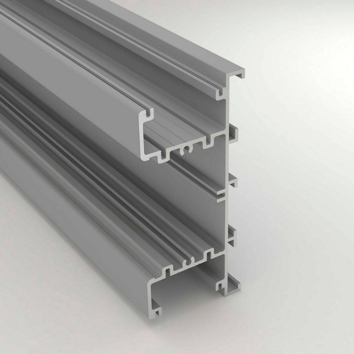 A 3D render of the Up & Down Wall Feature Lighting LED Profile ~ Model New Washington, a gray aluminum extrusion with multiple grooves for modular framing or LED strip accent lighting, is displayed on a light background.