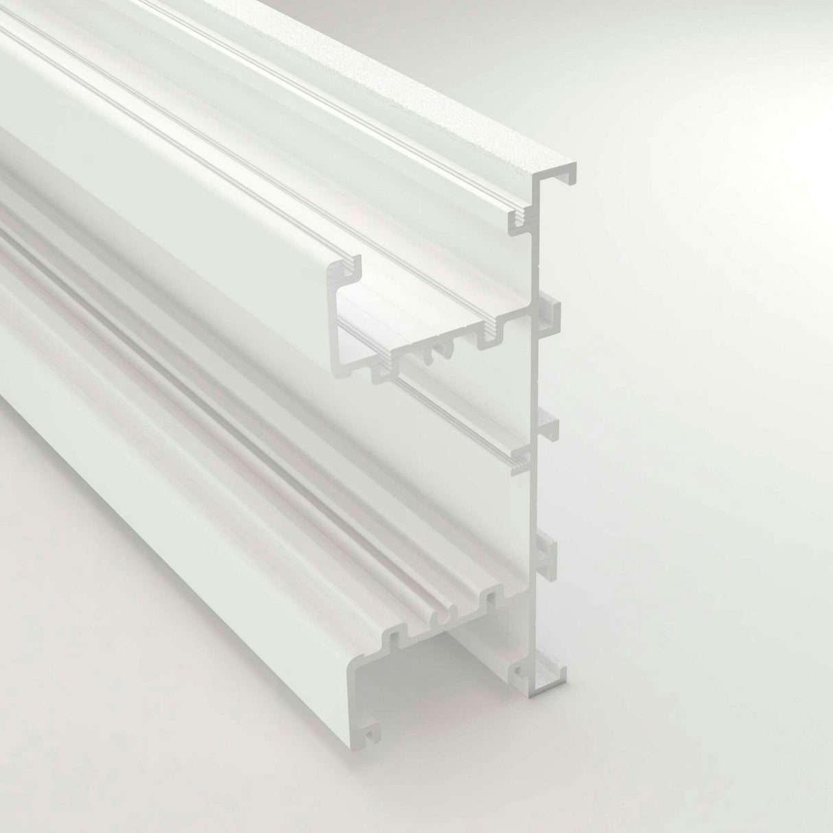 A close-up of the Up & Down Wall Feature Lighting LED Profile ~ Model New Washington, a white extruded aluminum profile with multiple grooves and channels, ideal for architectural accents or LED strip integration, shown isolated on a light background.