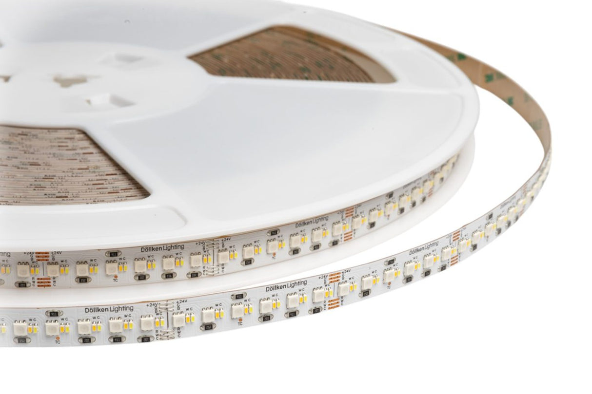 A close-up of the RGB+CCT IP20 LED Strip (24V) ~ Optimum Cromatic Series on a plastic reel, highlighting its small rectangular LEDs and tunable white electronic components along the flexible strip.