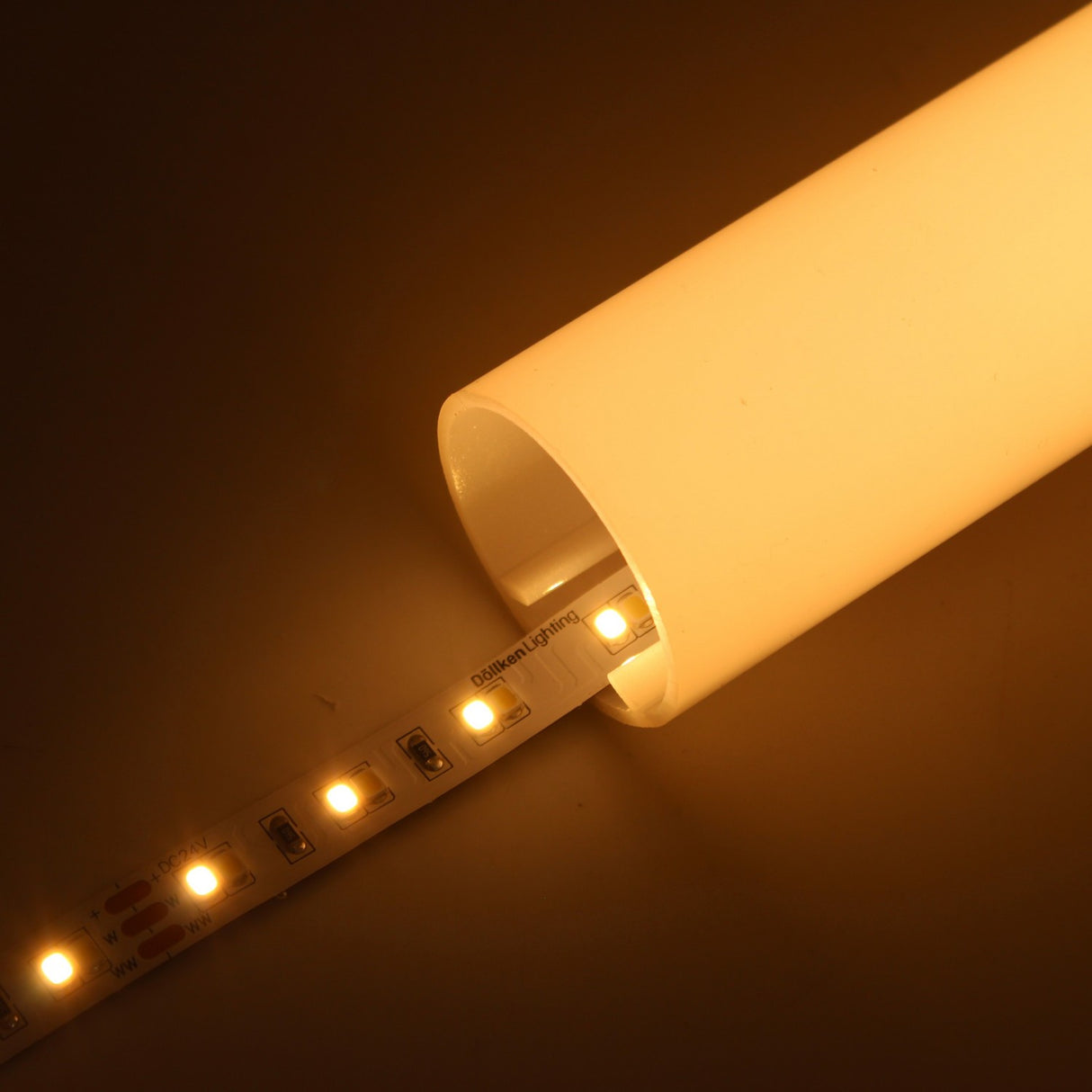 The High-CRI Tunable White IP20 LED Strip (24V) ~ Optimum Harmony Series emits adjustable warm light when placed in a translucent white tube, producing a soft ambient glow with tunable color temperature.