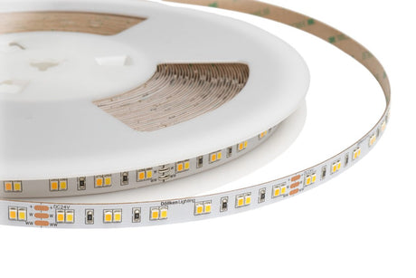 A close-up of the High-CRI Tunable White IP20 LED Strip (24V) ~ Optimum Harmony Series on a white spool, featuring visible yellow LED chips and electronic components on its flexible, color temperature-adjustable circuit board.