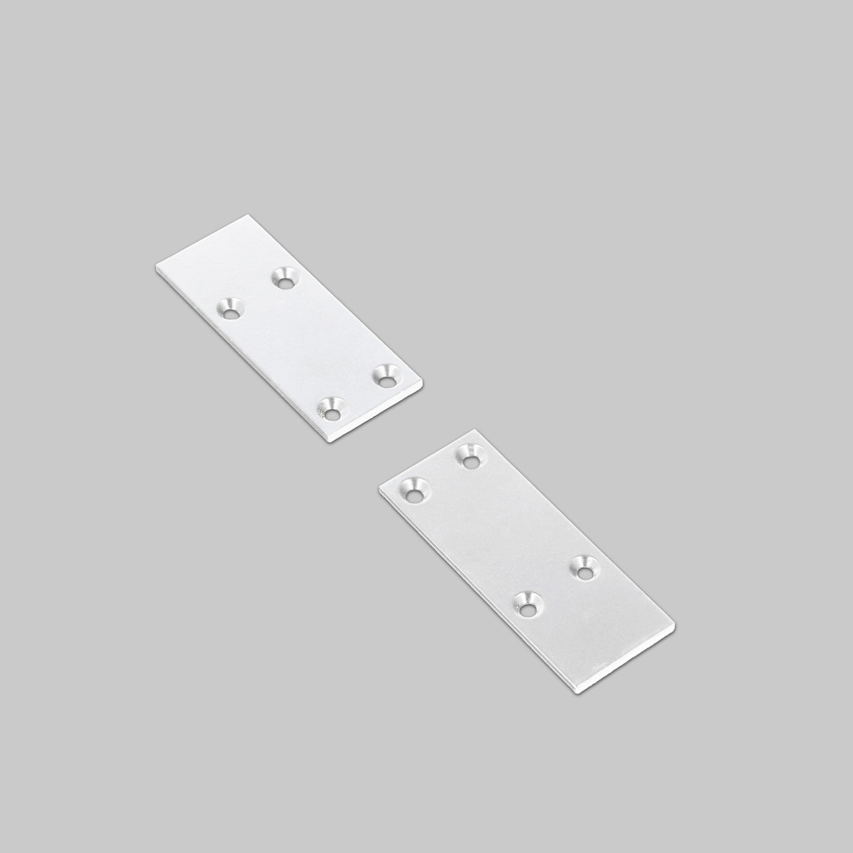 Two rectangular End Caps for Pixy20-02 Profile in silver metal, each featuring four countersunk screw holes, are displayed on a light gray background. The end caps are positioned parallel to each other and slightly angled apart.