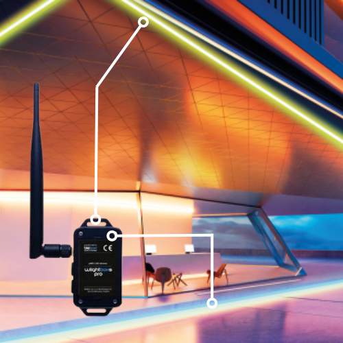A wireless sensor with an antenna connects to a modern building, highlighting integration with the Outdoor RGBW 4-Ch Wi-Fi LED Controller ~ wLightBox Pro by BleBox for smart lighting control in contemporary architecture.