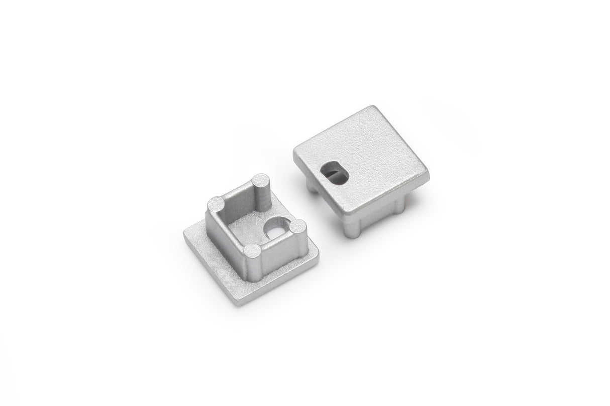The End Cap for Smart10 Profile set includes two small, square, silver-finished metallic caps—one with a hollow interior and posts, the other flat with a rectangular cutout—designed for lighting fixture installations.