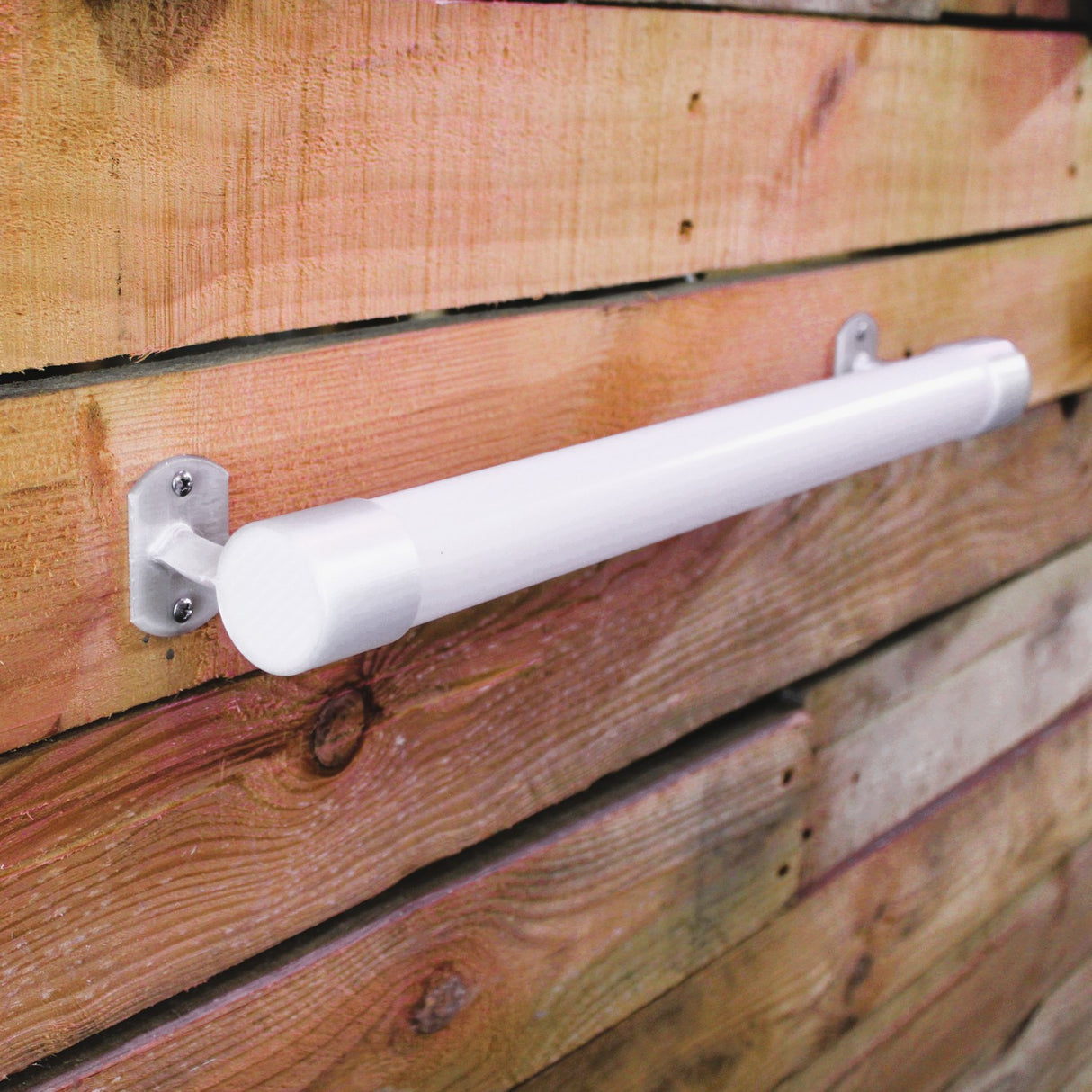 A Wired Post for 1.50 Round Profiles is securely mounted horizontally on a wooden plank wall, held firmly by metal brackets at each end.