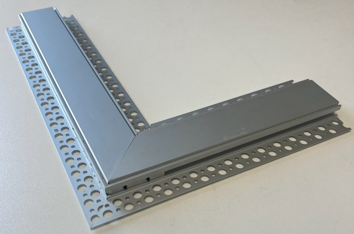 The L Bracket for TL-041 Profile has a grey finish, perforated edges with evenly spaced round holes, and forms a right angle. It rests on a light surface. Bulk pricing is available.