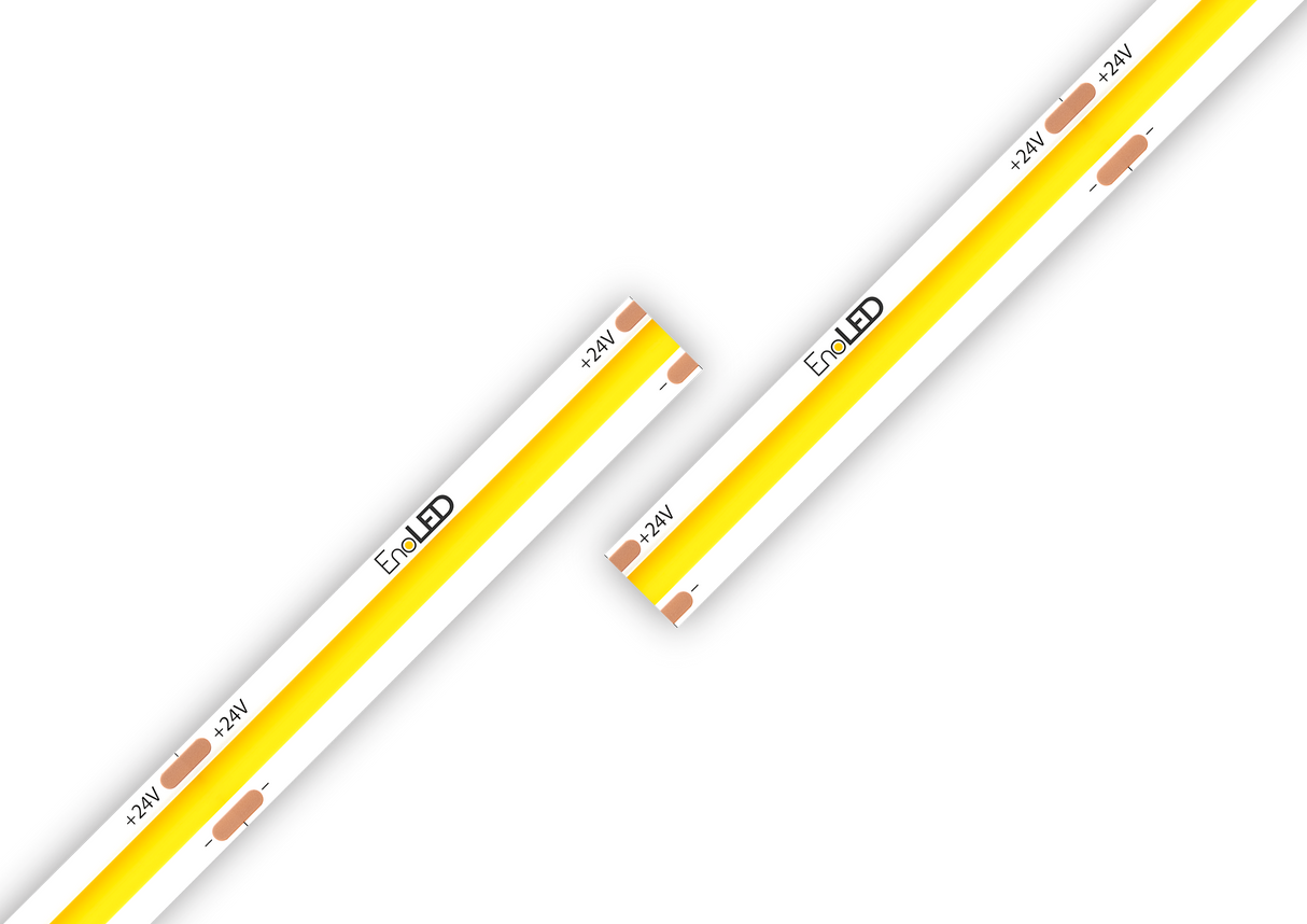 Two white High Brightness IP20 COB LED strips (24V) from the UniPlus Series, featuring yellow, dot-free illumination and labeled "EvoLED," are displayed against a white background. The strips are arranged diagonally and nearly touching at an angle, with copper connection points visible—making them ideal for seamless under-cabinet lighting solutions.