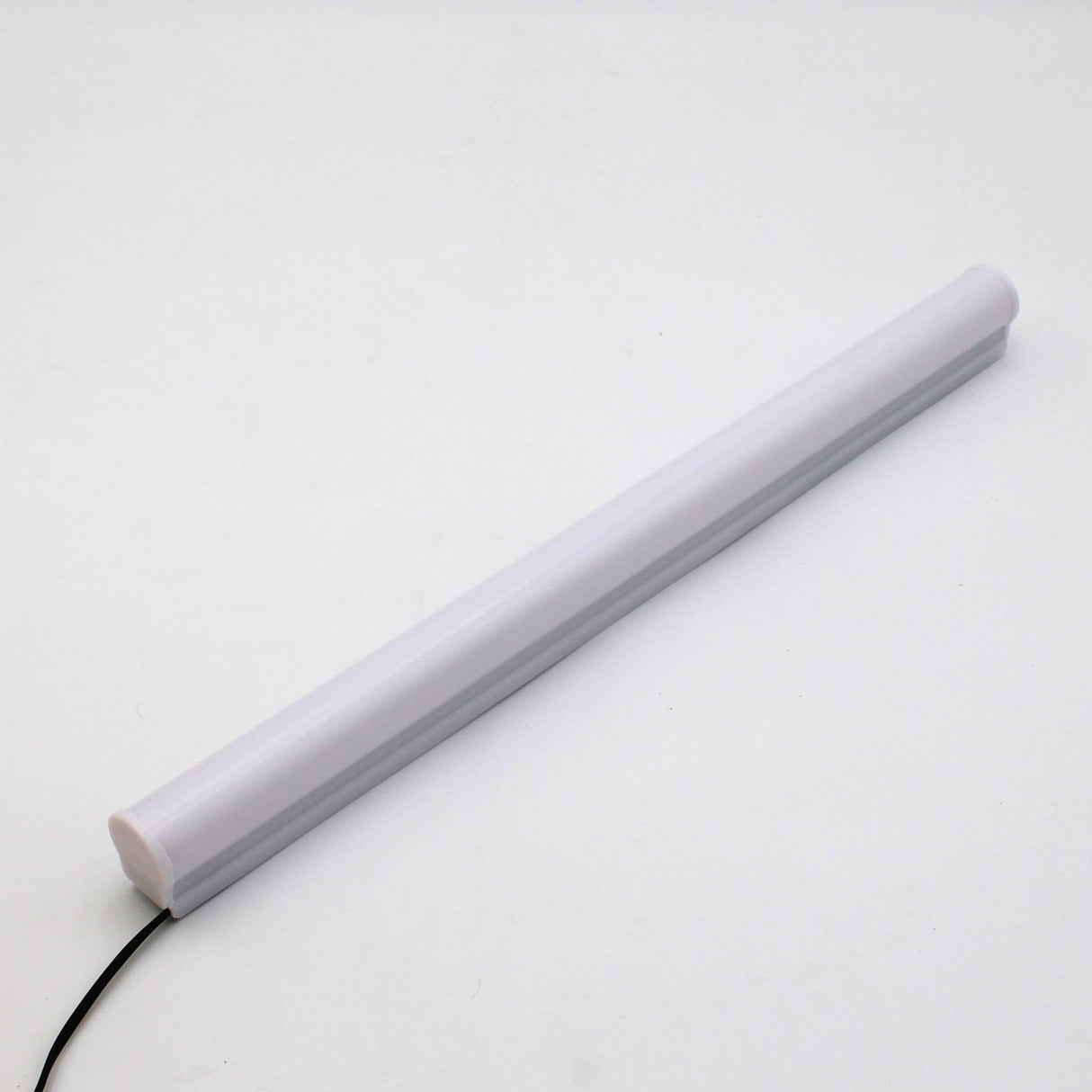 A Hi-Lite 30 Field Adjustable White Border Contour Tube Light, featuring a white cylindrical design and black power cord, is displayed diagonally on a plain white background—perfect for modern building illumination.